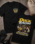 Front and back of black Duck Racing T-shirt with a checkered-flag chest emblem and helmeted cartoon duck driving a yellow hot rod amid smoke and flying engine parts.