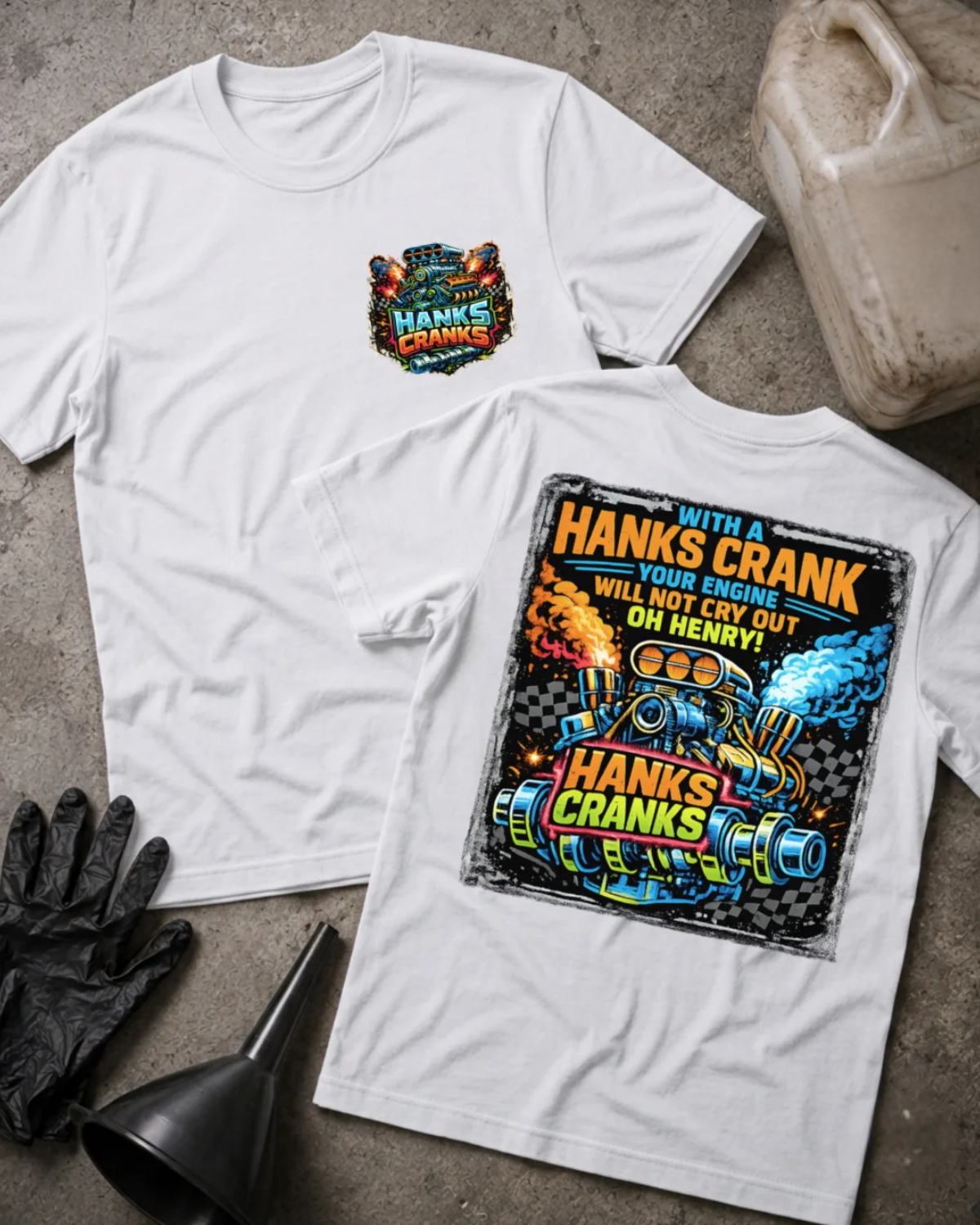 Front and back of white Hanks Cranks T-shirt with a small engine chest emblem and colorful racing engine and crankshaft back graphic with checkered flags, orange flames and blue smoke.