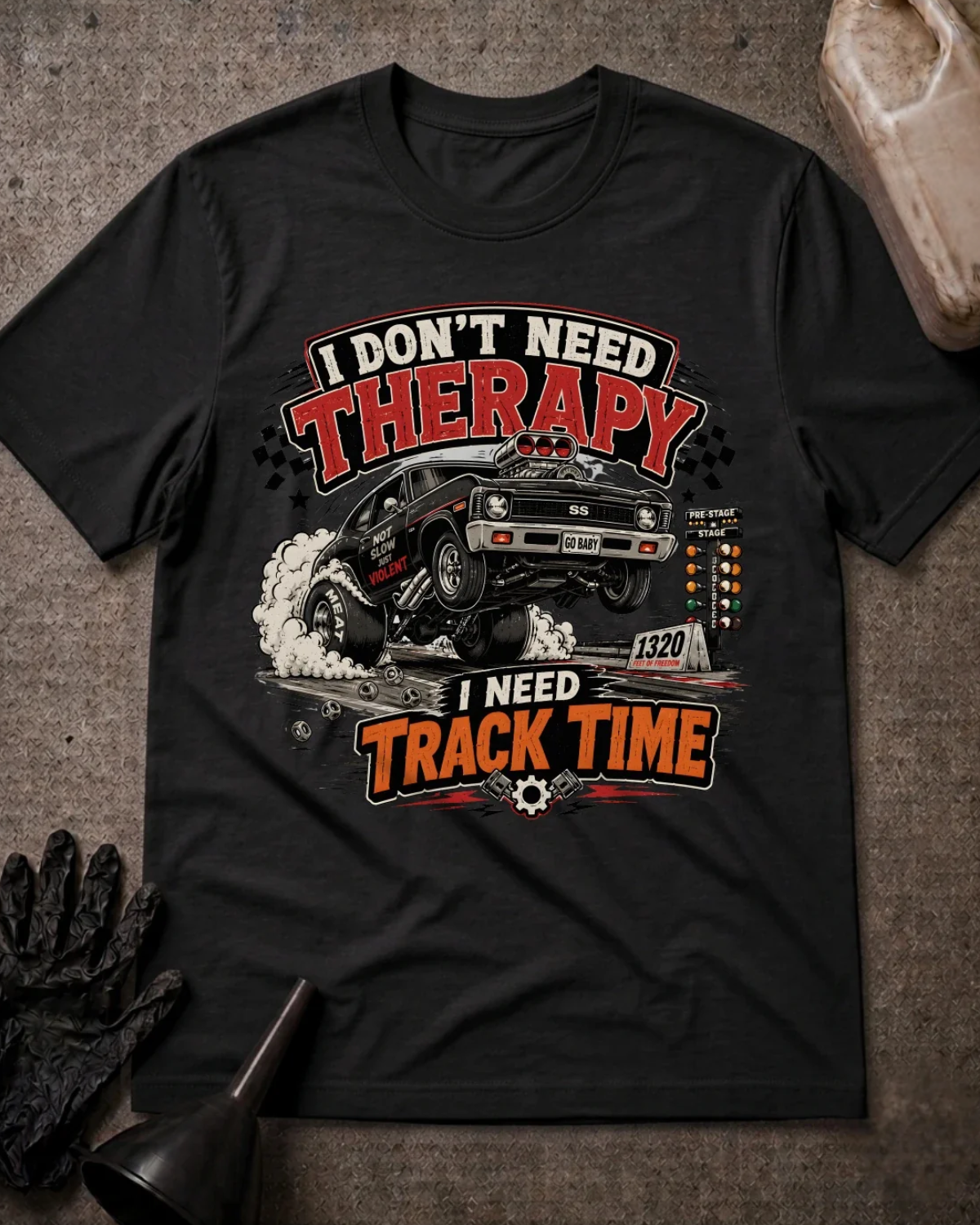 Front of black T-shirt with a black drag car lifting its front wheels beside a starting tree, reading “I Don’t Need Therapy, I Need Track Time.”