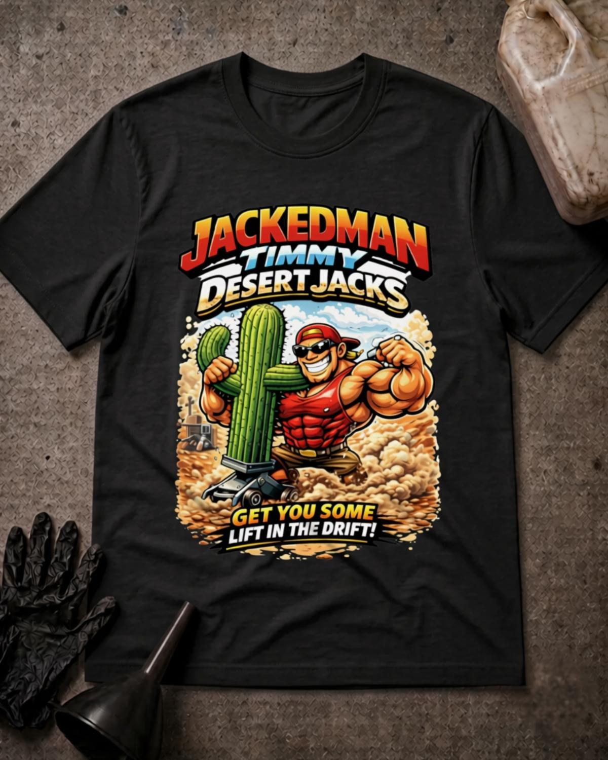 Black Jackedman Timmy Desert Jacks T-shirt featuring a muscular cartoon man in sunglasses beside a cactus on a floor jack, with a dusty desert background and “Get you some lift in the drift!”