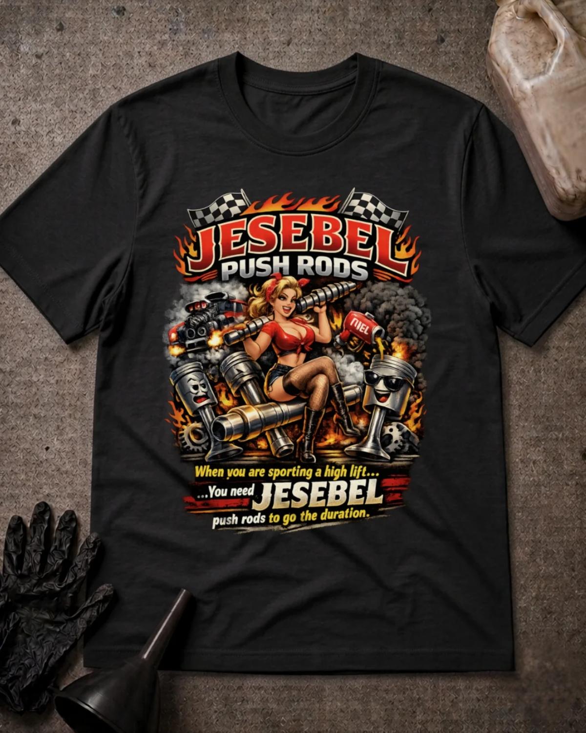 Front of black Jesebel Push Rods T-shirt with a pinup woman holding an engine camshaft amid cartoon pistons, flames, smoke and checkered flags.