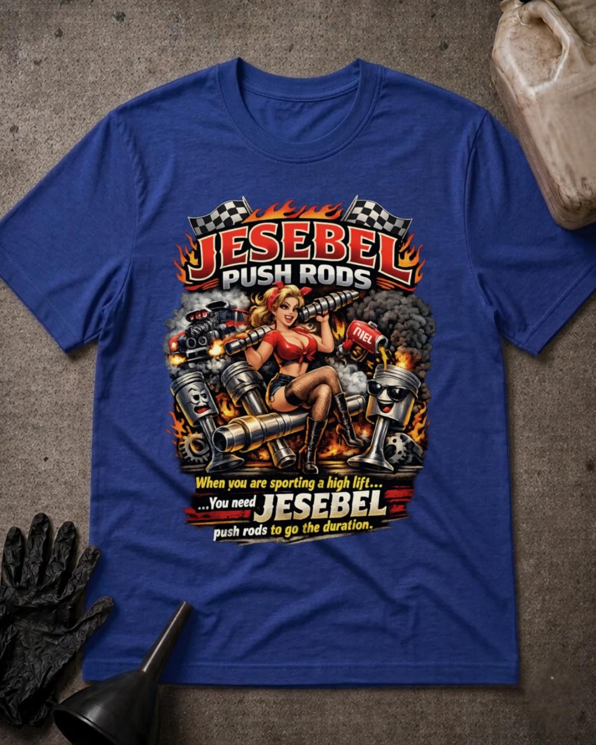 Front of true royal blue Jesebel Push Rods T-shirt with a pinup woman holding an engine camshaft amid cartoon pistons, flames, smoke and checkered flags.