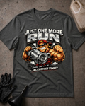Front of dark grey heather T-shirt with muscular cartoon Jackedman Timmy in sunglasses and a red cap holding a turbocharger beneath “Just One More Run.”