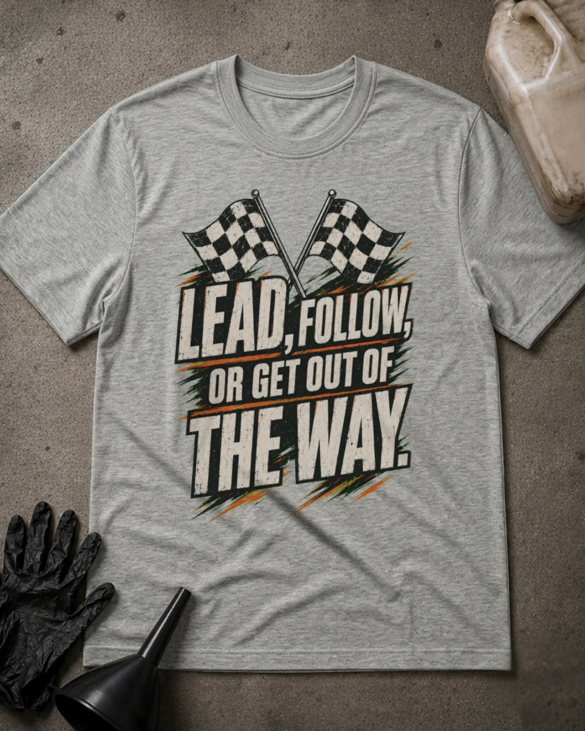 Front of athletic heather grey T-shirt with crossed checkered racing flags and distressed lettering reading “Lead, Follow, or Get Out of the Way.”