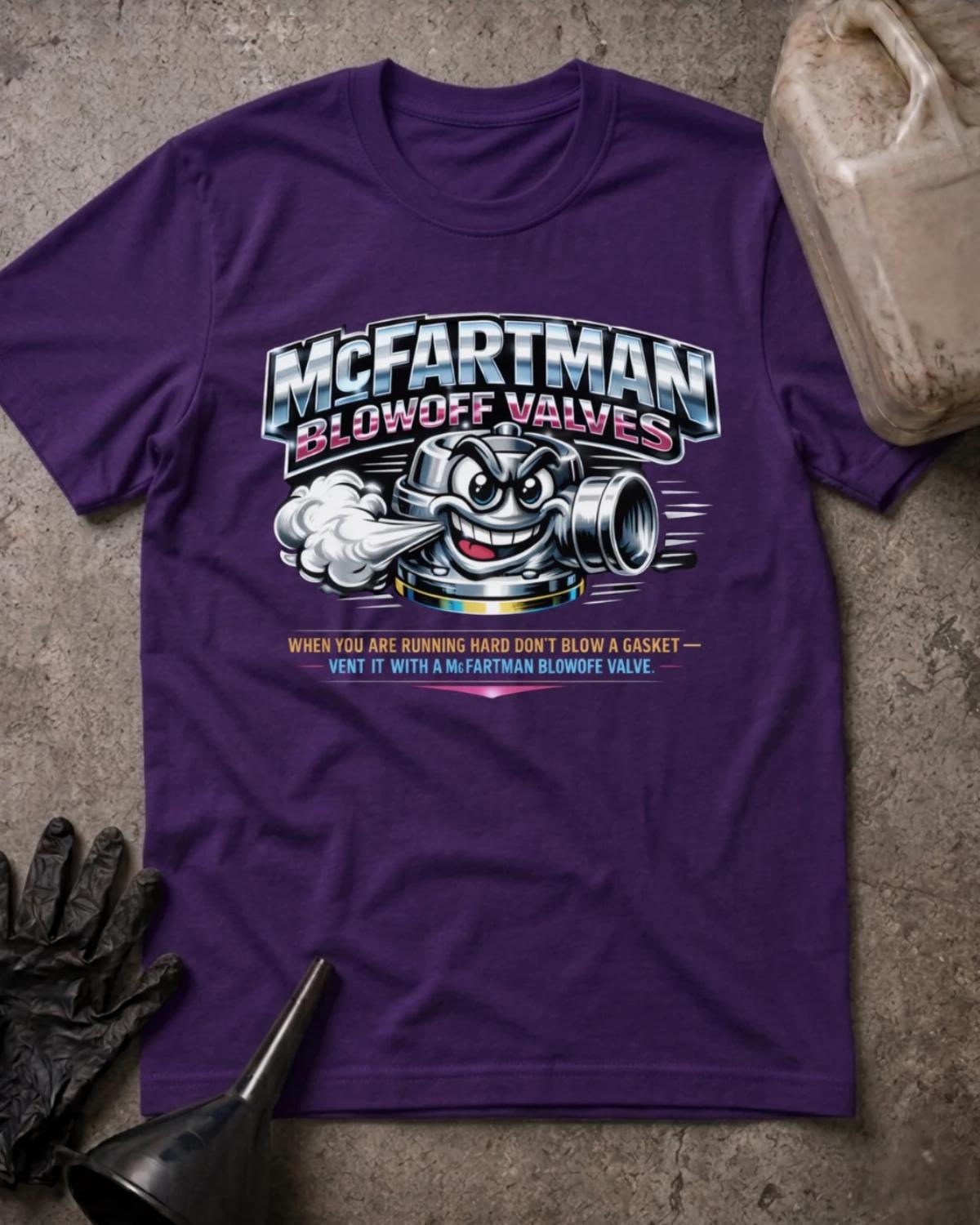 Front of team purple T-shirt with a grinning cartoon automotive blowoff valve venting air beneath silver and pink “McFartman Blowoff Valves” lettering.