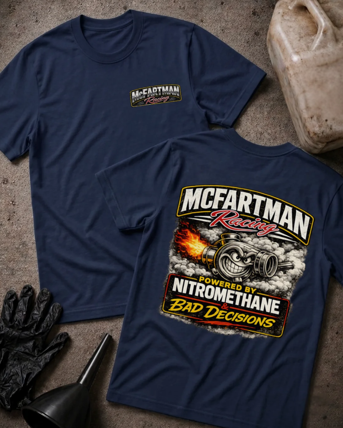 Front and back of navy McFartman Racing T-shirt with a chest logo and grinning turbocharger amid flames and smoke, reading “Powered by Nitromethane & Bad Decisions.”