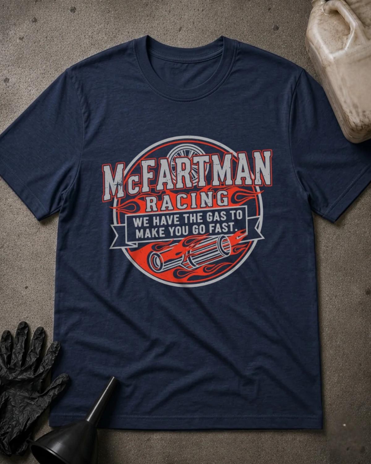 Navy McFartman Racing T-shirt featuring a circular emblem with red flames, exhaust pipes, a wheel, and the slogan “We have the gas to make you go fast.”