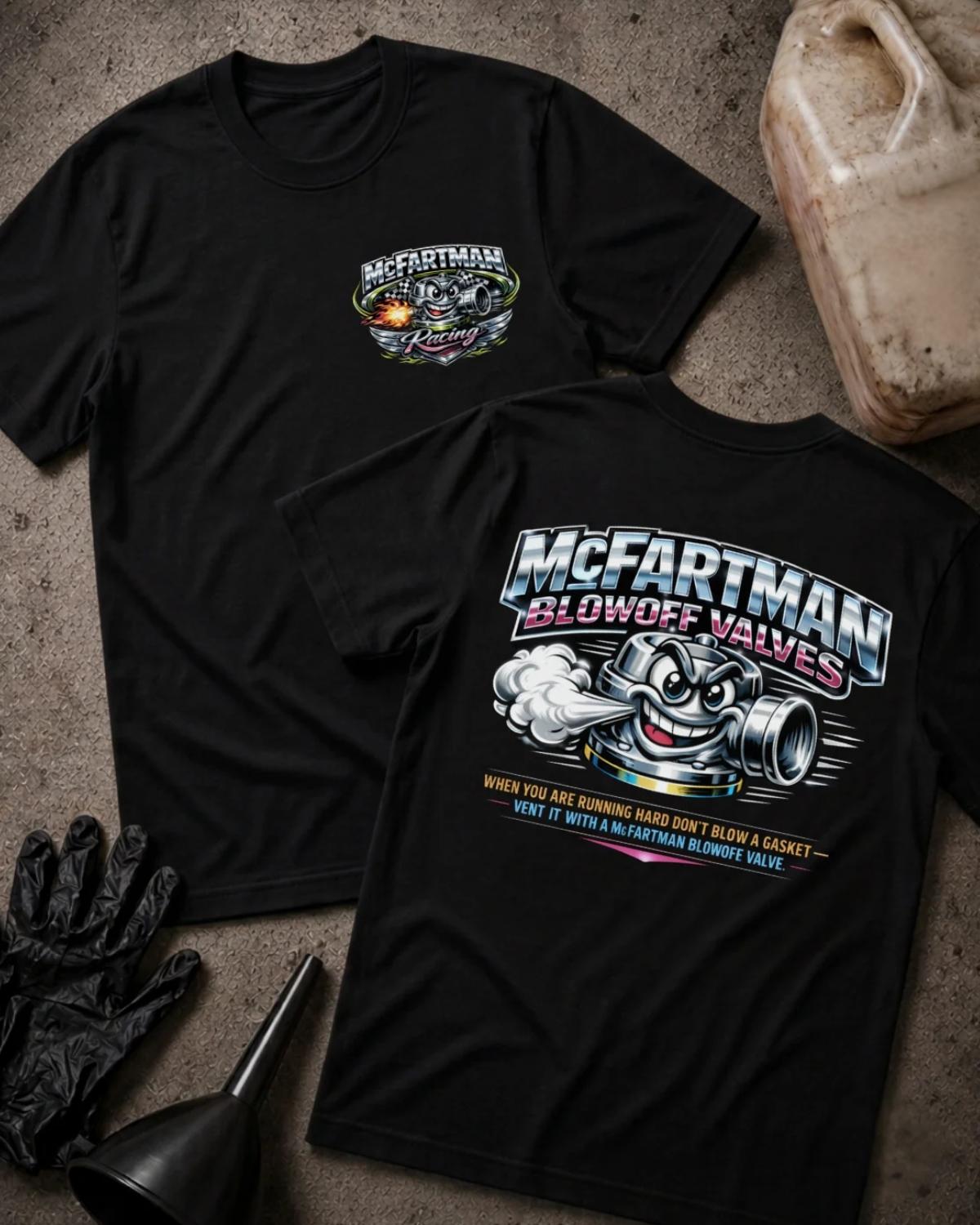 Front and back of black McFartman Racing T-shirt with a chest logo and grinning cartoon automotive blowoff valve venting air beneath “McFartman Blowoff Valves.”