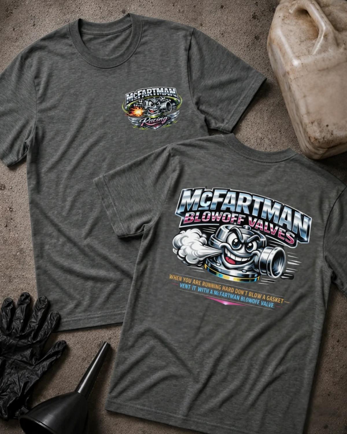 Front and back of dark grey heather McFartman Racing T-shirt with a chest logo and grinning cartoon automotive blowoff valve venting air beneath “McFartman Blowoff Valves.”