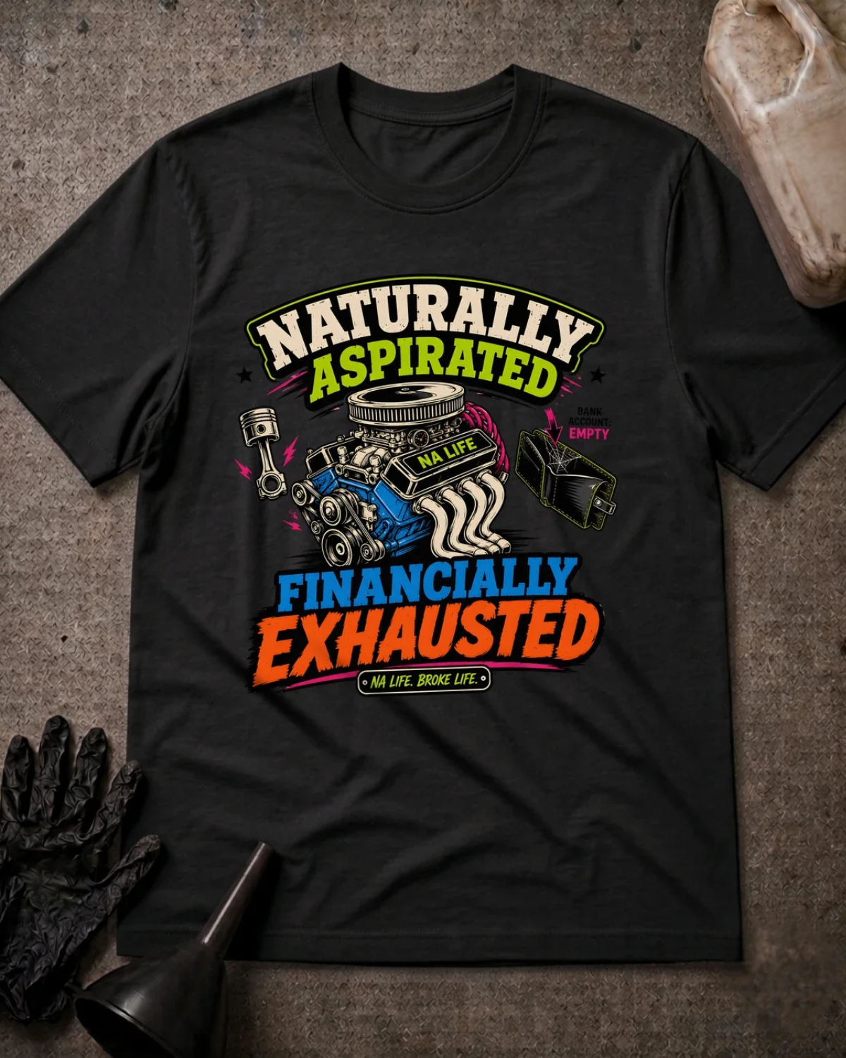 Front of black T-shirt with an engine, piston and empty wallet graphic reading “Naturally Aspirated, Financially Exhausted.”