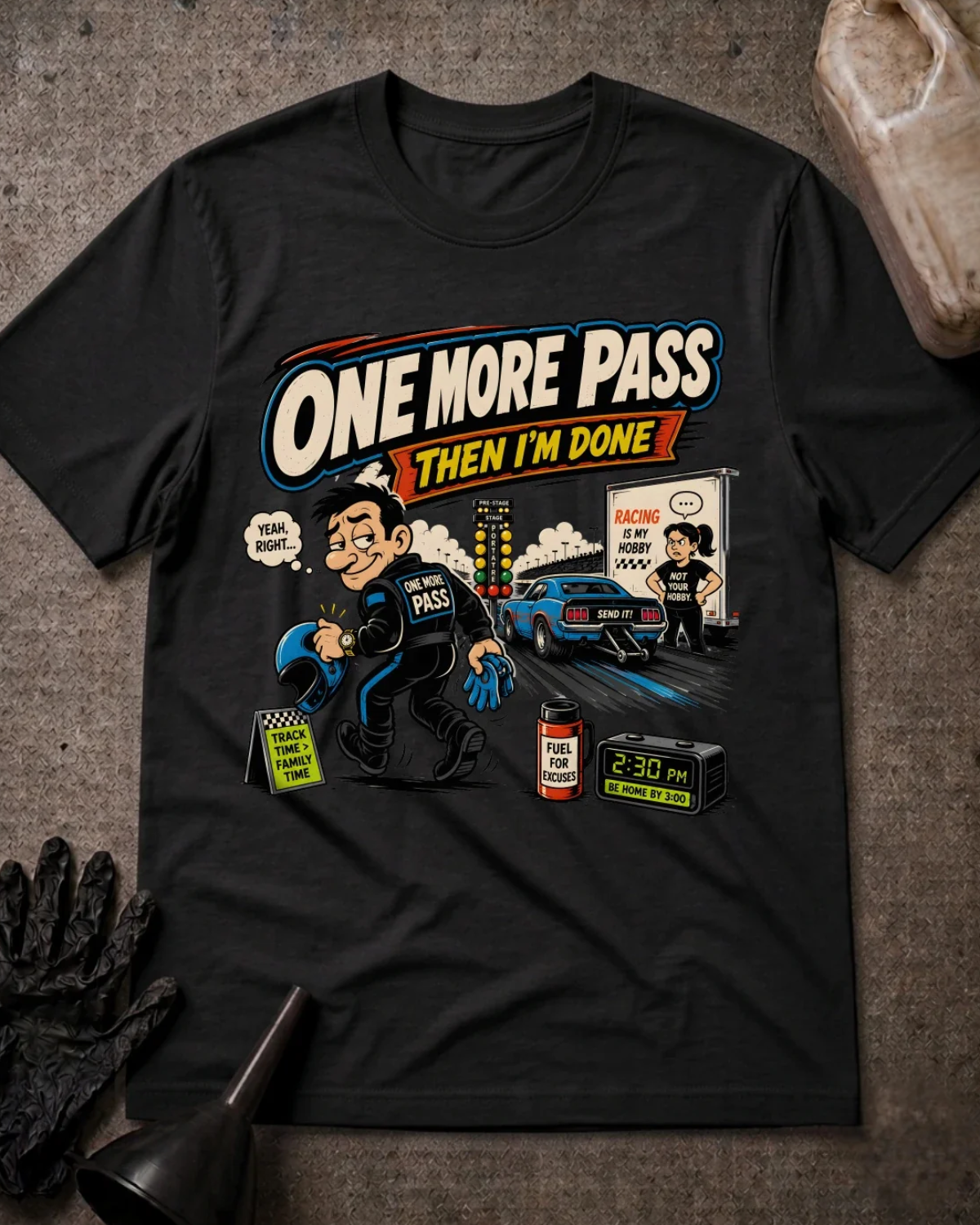 Front of black T-shirt with a cartoon racer holding a helmet, blue drag car and woman beside a trailer, reading “One More Pass, Then I’m Done.”