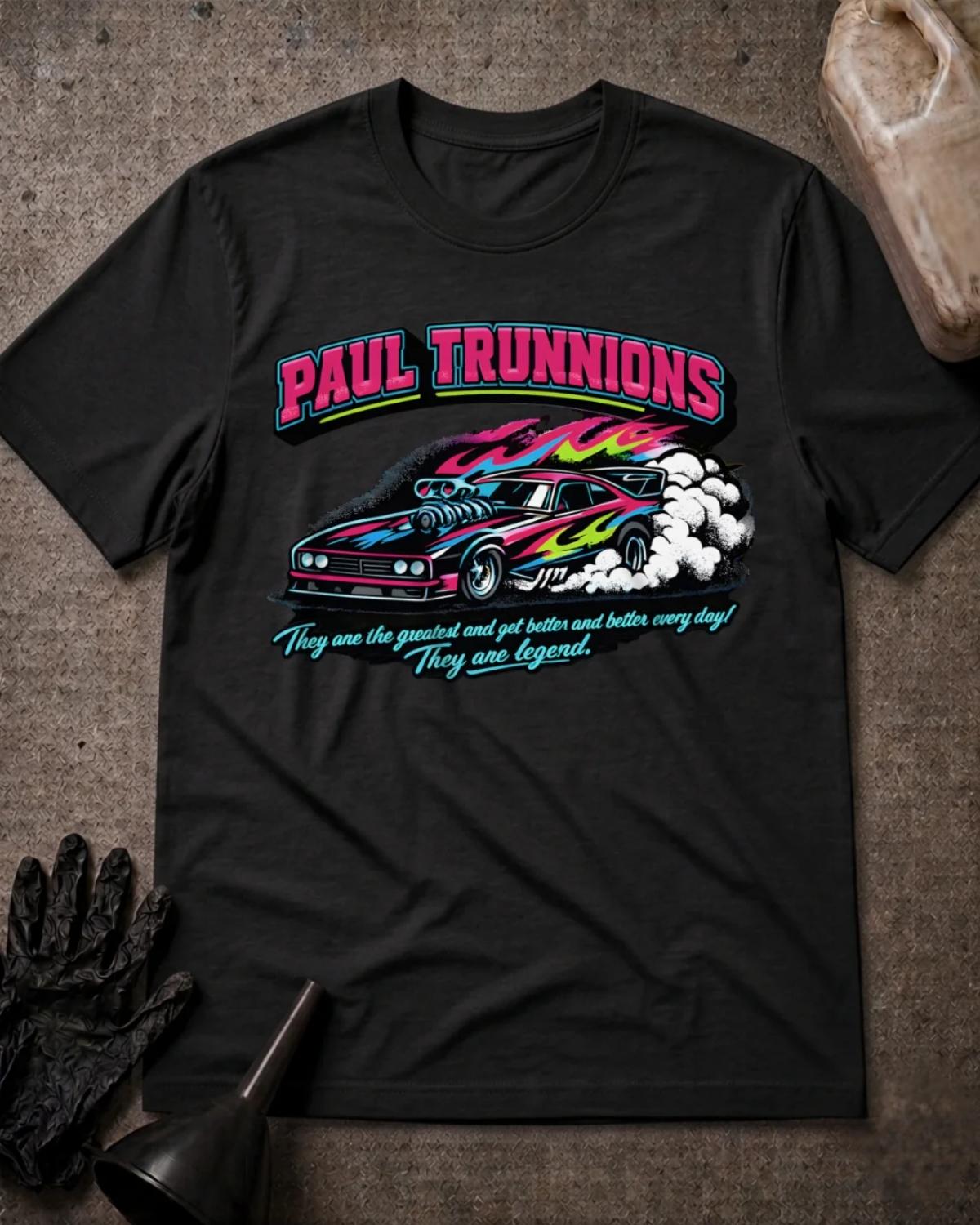 Front of black Paul Trunnions T-shirt with pink lettering above a supercharged drag car with pink, blue and lime flame graphics amid white tire smoke.