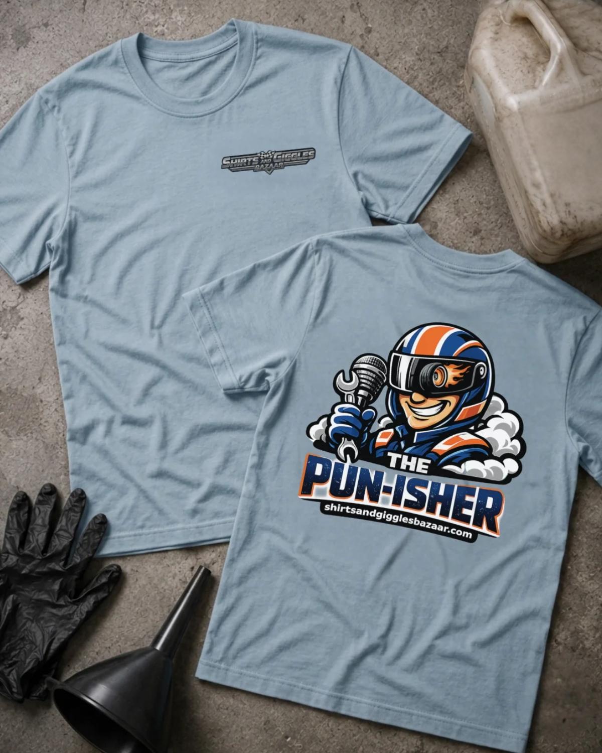 Light Blue Shirts & Giggles Bazaar T-shirt, front and back views with a small chest logo and colorful back graphic of a helmeted racer holding a microphone and wrench, plus “The Pun-isher” lettering.