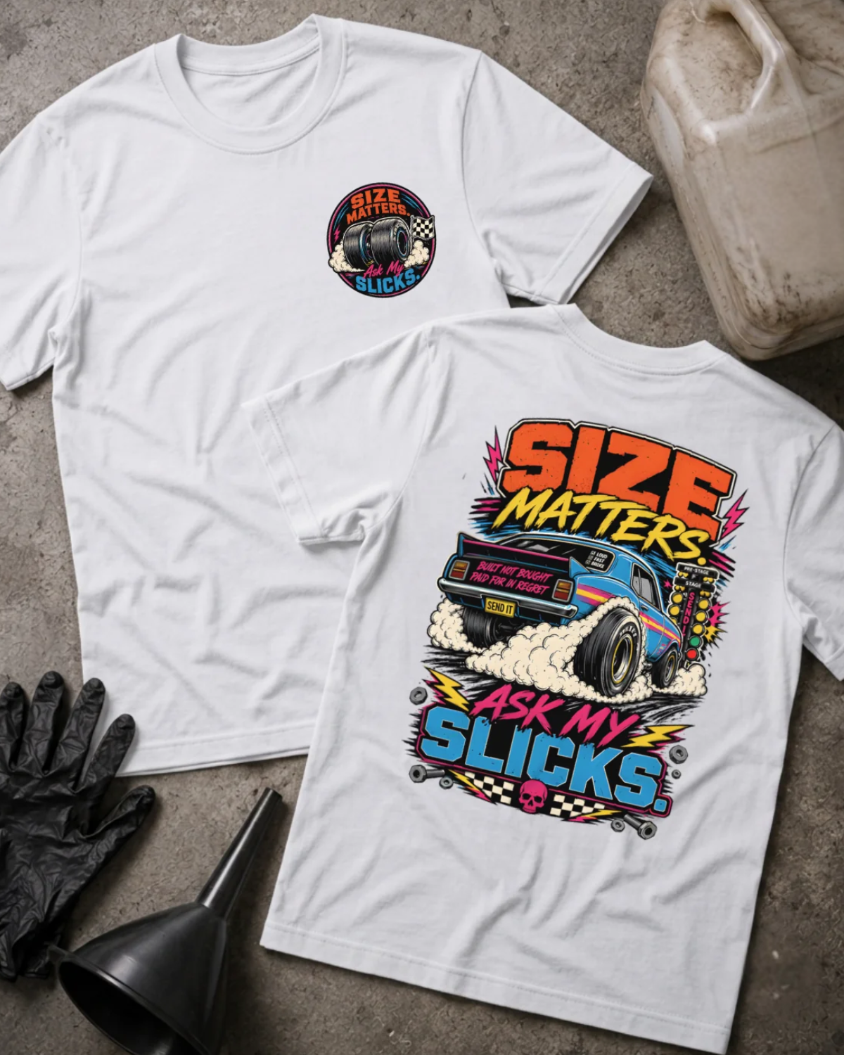Front and back of white “Size Matters, Ask My Slicks” T-shirt with a small tire chest emblem and blue drag car with oversized rear slicks and tire smoke on the back.