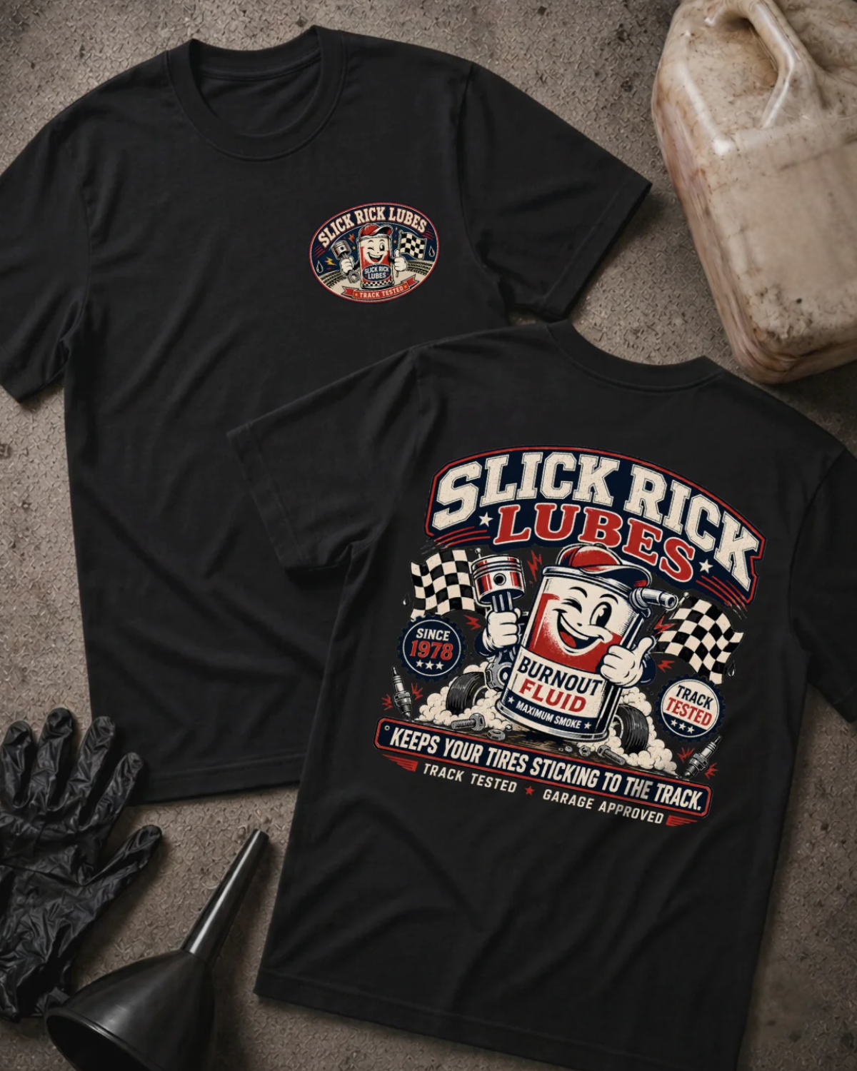Front and back of black Slick Rick Lubes T-shirt with a chest logo and cartoon “Burnout Fluid” can holding an engine piston amid tires, smoke and checkered flags.