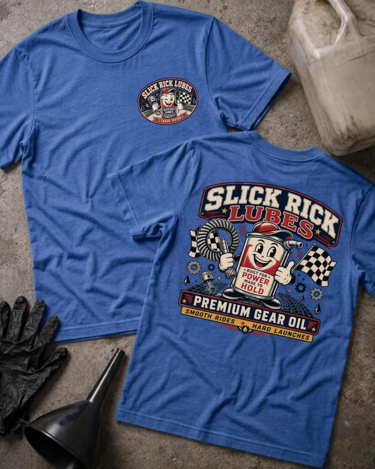 Front and back of heather true royal blue Slick Rick Lubes T-shirt with a chest logo and cartoon automotive oil can holding a gear, checkered flags and “Premium Gear Oil” back print.