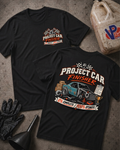 Project Car Finisher t-shirt in black showing front chest logo and full back print of a disassembled project car with text '0% Complete, 100% Optimistic'