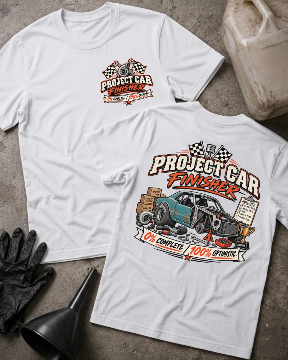 Front and back of Project Car Finisher white T-shirt with chest logo, unfinished teal car surrounded by parts and tools, and “0% complete / 100% optimistic” slogan.