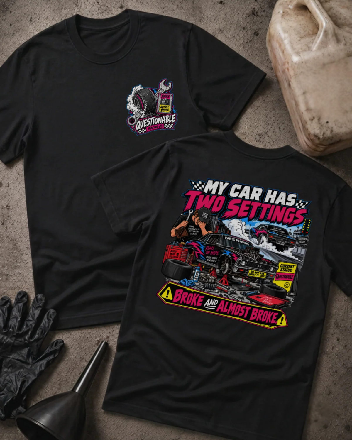 Front and back of Questionable Racing Co. black T-shirt with chest logo, mechanic beside a car on jack stands, and “My car has two settings: broke and almost broke” slogan.