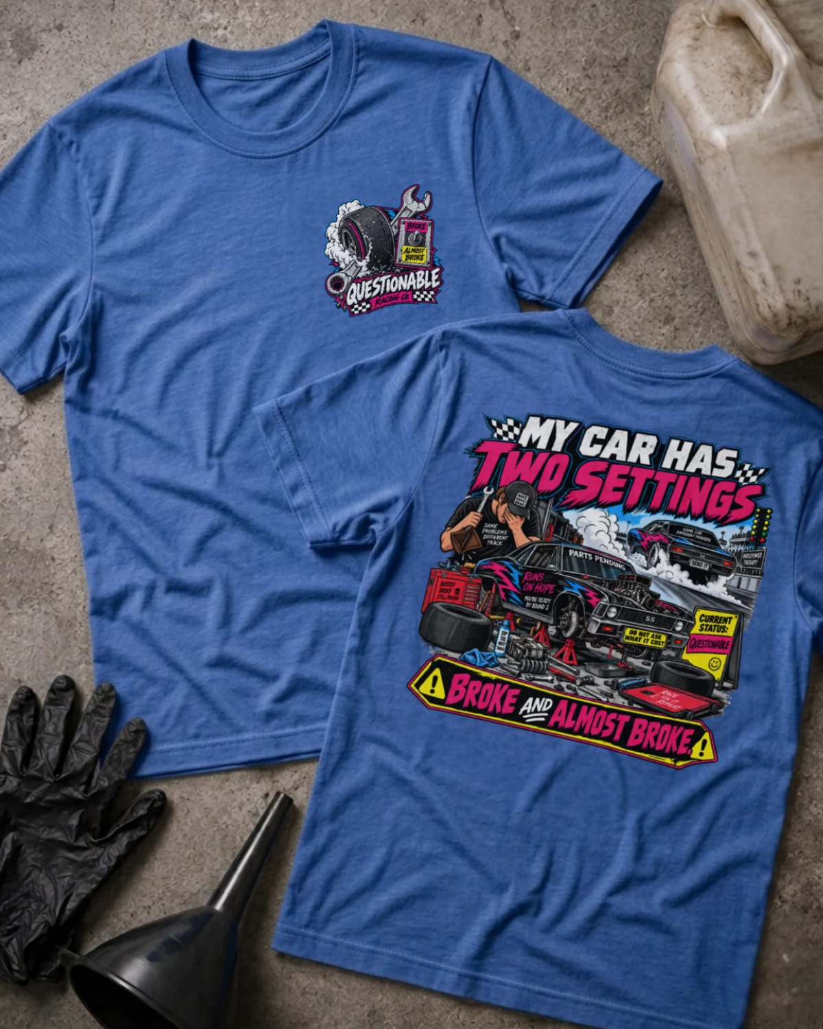 Front and back of Questionable Racing Co. heather true royal T-shirt with chest logo, mechanic beside a car on jack stands, and “My car has two settings: broke and almost broke” slogan.
