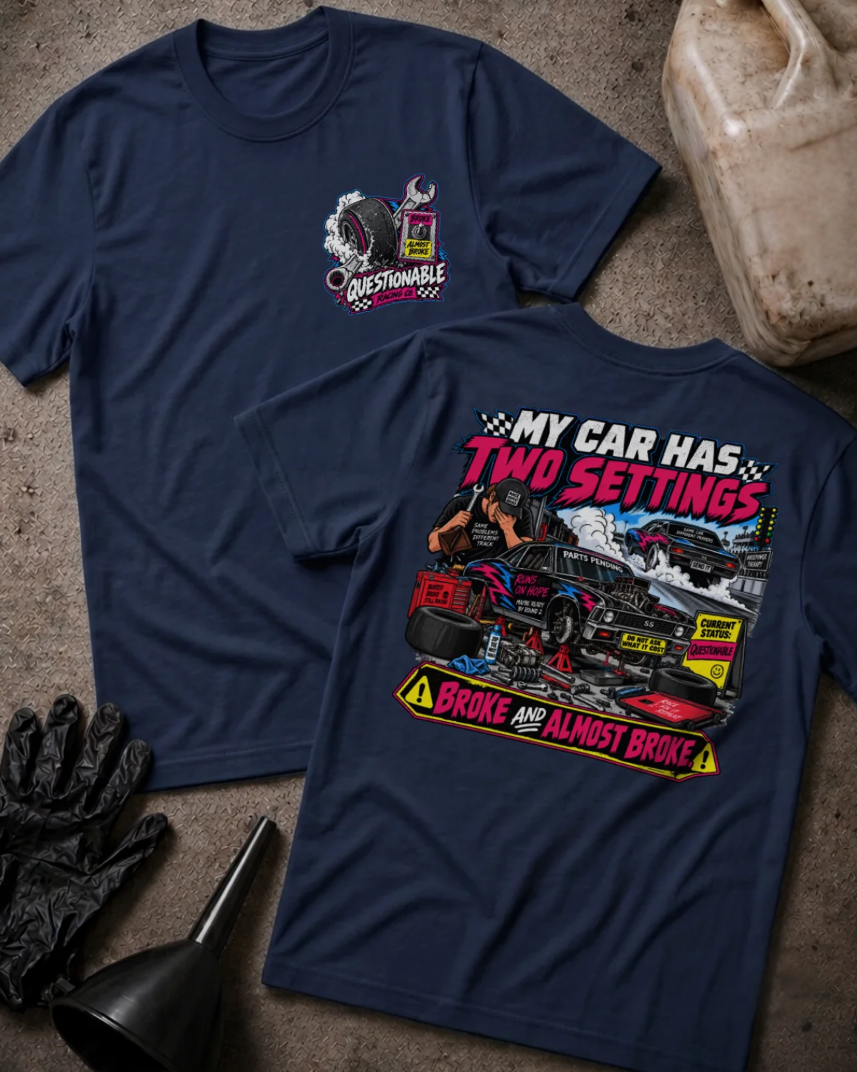 Front and back of Questionable Racing Co. navy T-shirt with chest logo, mechanic beside a car on jack stands, and “My car has two settings: broke and almost broke” slogan.