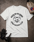 A white short-sleeve graphic T-shirt laid flat on a textured dark surface, surrounded by racing-themed props including a black glove, funnel, and a bottle with a visible VP logo. The shirt graphic reads 'RACE OR GO HOME DRAG RACERS CLUB' around an engine illustration.