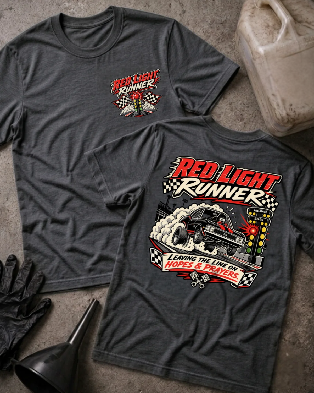 Front and back of Red Light Runner dark grey heather T-shirt with chest logo, black drag car launching beside a glowing red starting light, and “Leaving the line on hopes & prayers” slogan.