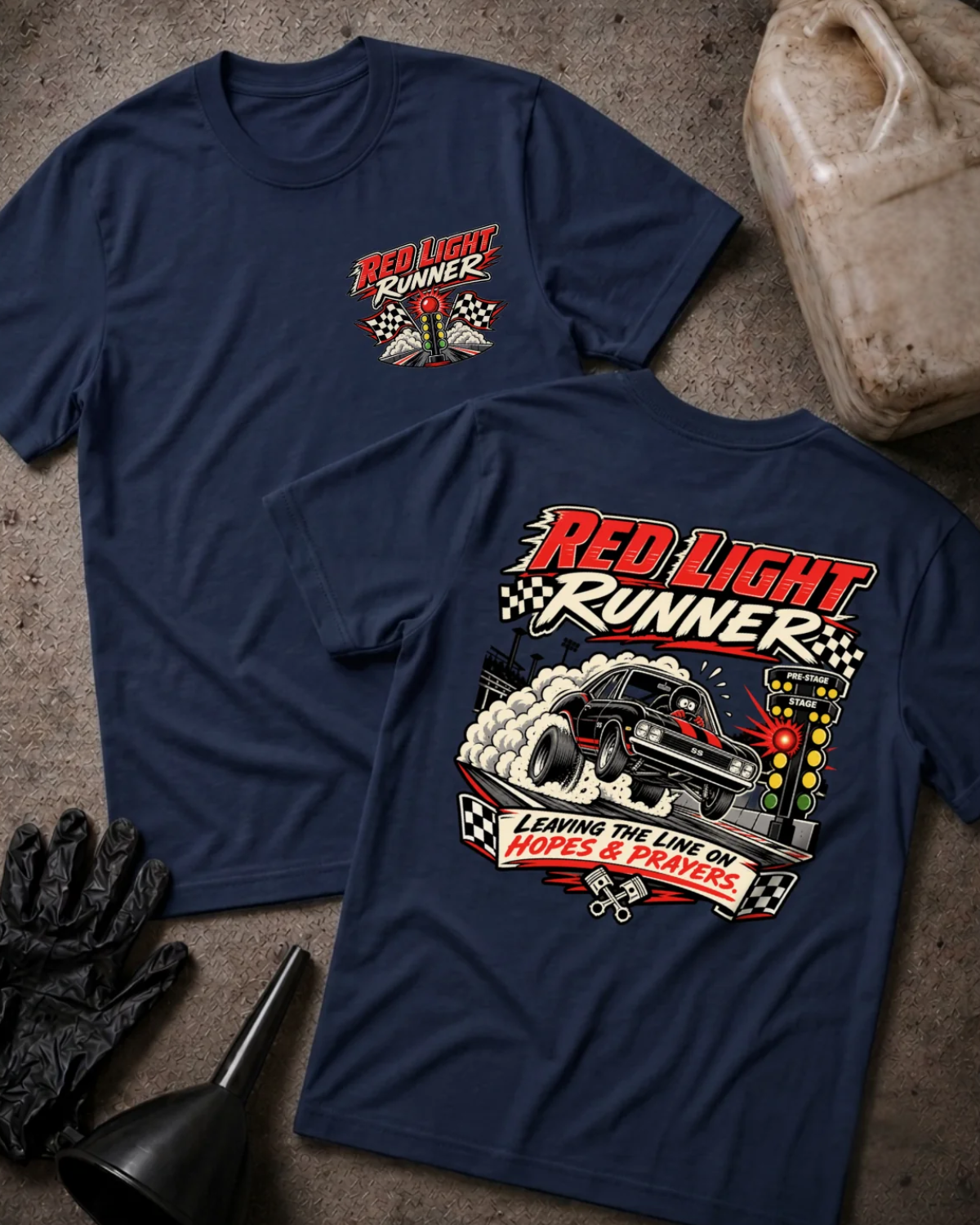 Front and back of Red Light Runner navy T-shirt with chest logo, black drag car launching beside a glowing red starting light, and “Leaving the line on hopes & prayers” slogan.