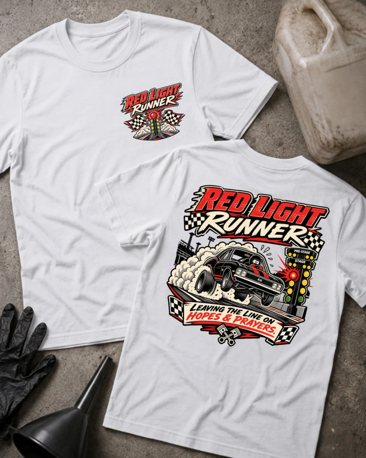 Front and back of Red Light Runner white T-shirt with chest logo, black drag car launching beside a glowing red starting light, and “Leaving the line on hopes & prayers” slogan.