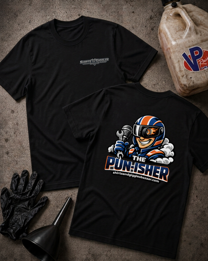 Two black short-sleeve t-shirts displayed on a textured gray surface, with one showing a small chrome chest logo and the other showing a large back graphic of a cartoon race car driver holding a wrench with the text 'THE PUNISHER' and 'shirtsandgigglesbazaar.com'