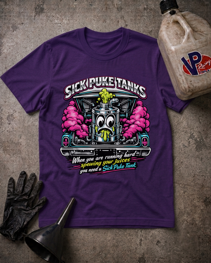 A purple graphic t-shirt laid flat on a textured gray surface, surrounded by black gloves, a metal funnel, and an oil jug. The t-shirt features a cartoon hot rod engine with pink smoke, the text 'SICK PUKE TANKS', and a humorous quote about running hard and needing a SICK Puke Tank.