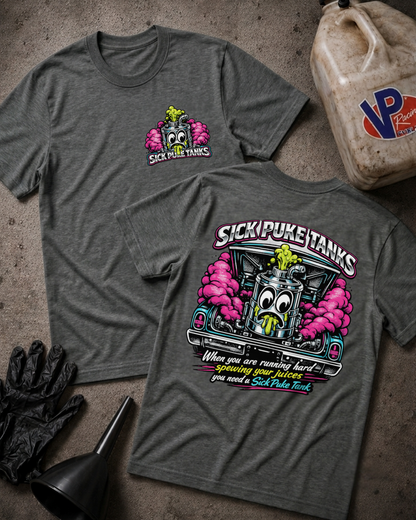 Two heather dark gray t-shirts displayed flat on a textured concrete surface, showing both the front and back designs. The front features a small pink and green cartoon tank graphic with the text 'SICK PUKE TANKS'.