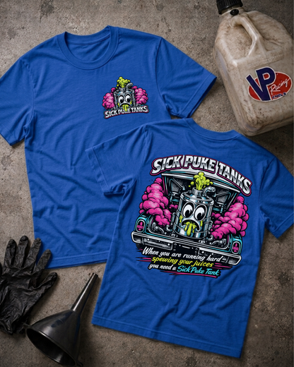 Two blue graphic T-shirts laid flat on a textured gray surface, with a black oil jug, black gloves, and a funnel nearby. The front shirt shows a small chest graphic of a cartoon gas pump with pink smoke and the text 'SICK PUKE TANKS.