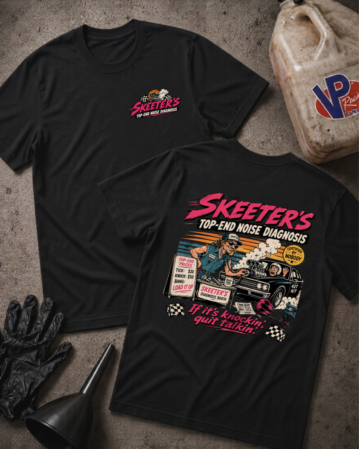 Two black graphic T-shirts laid flat on a textured gray surface, with automotive-themed printed artwork and the text 'SKEETER'S TOP-END NOISE DIAGNOSIS.' One shirt shows a small chest logo, and the other shows a large back graphic with an race illustration and the phrase 'If it's knocking, quit talking'.
