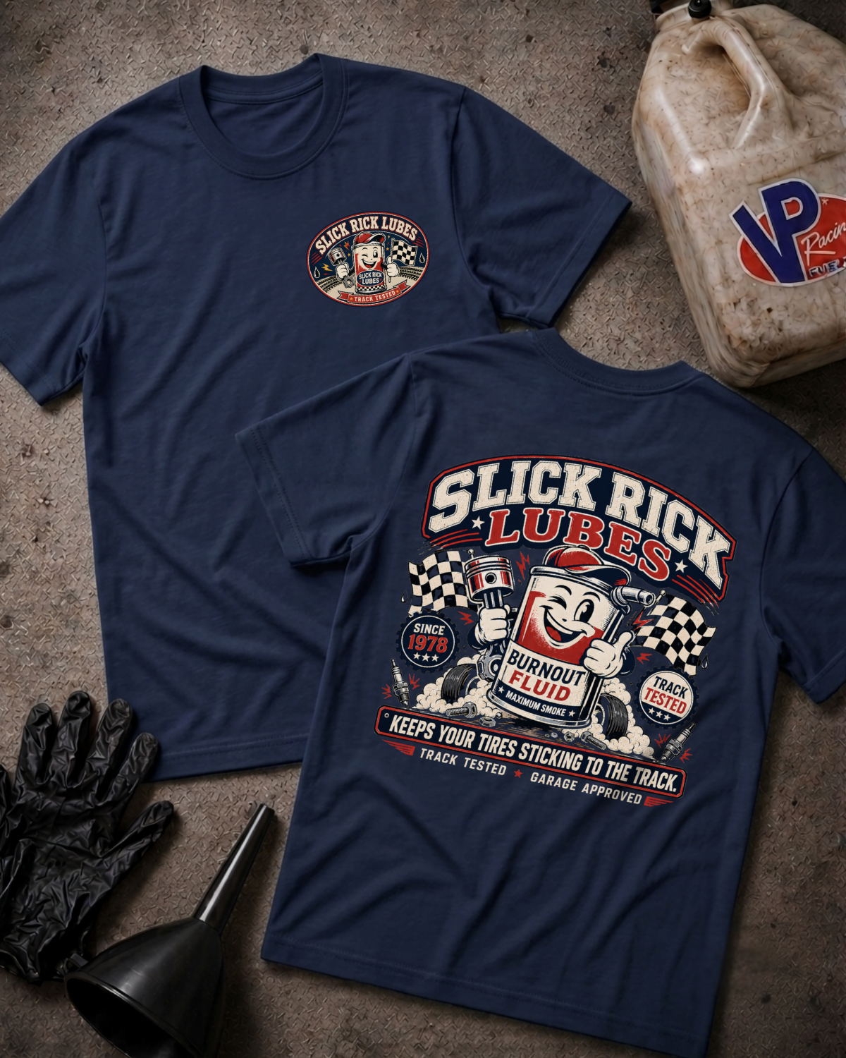 Two navy blue t-shirts shown flat on a textured gray surface, displaying the front and back graphics for 'Slick Rick Lubes'. The front features a small circular chest logo, while the back has a large graphic with a cartoon character, checkered flags, and text.