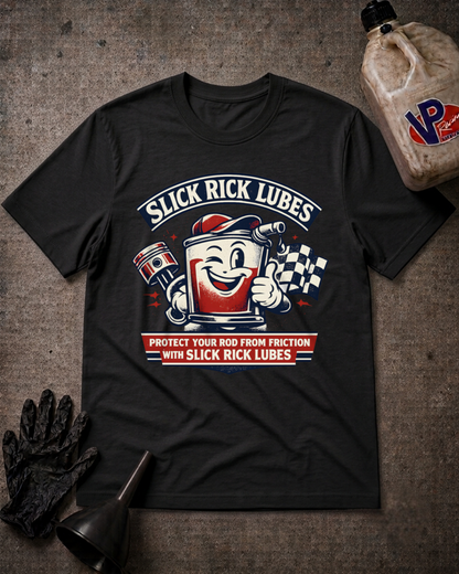 A black graphic t-shirt featuring a retro-style oil can mascot and the text 'SLICK RICK LUBES' and 'PROTECT YOUR ROD FROM FRICTION WITH SLICK RICK LUBES', laid flat on a textured gray background with a bottle, gloves, and funnel as props.