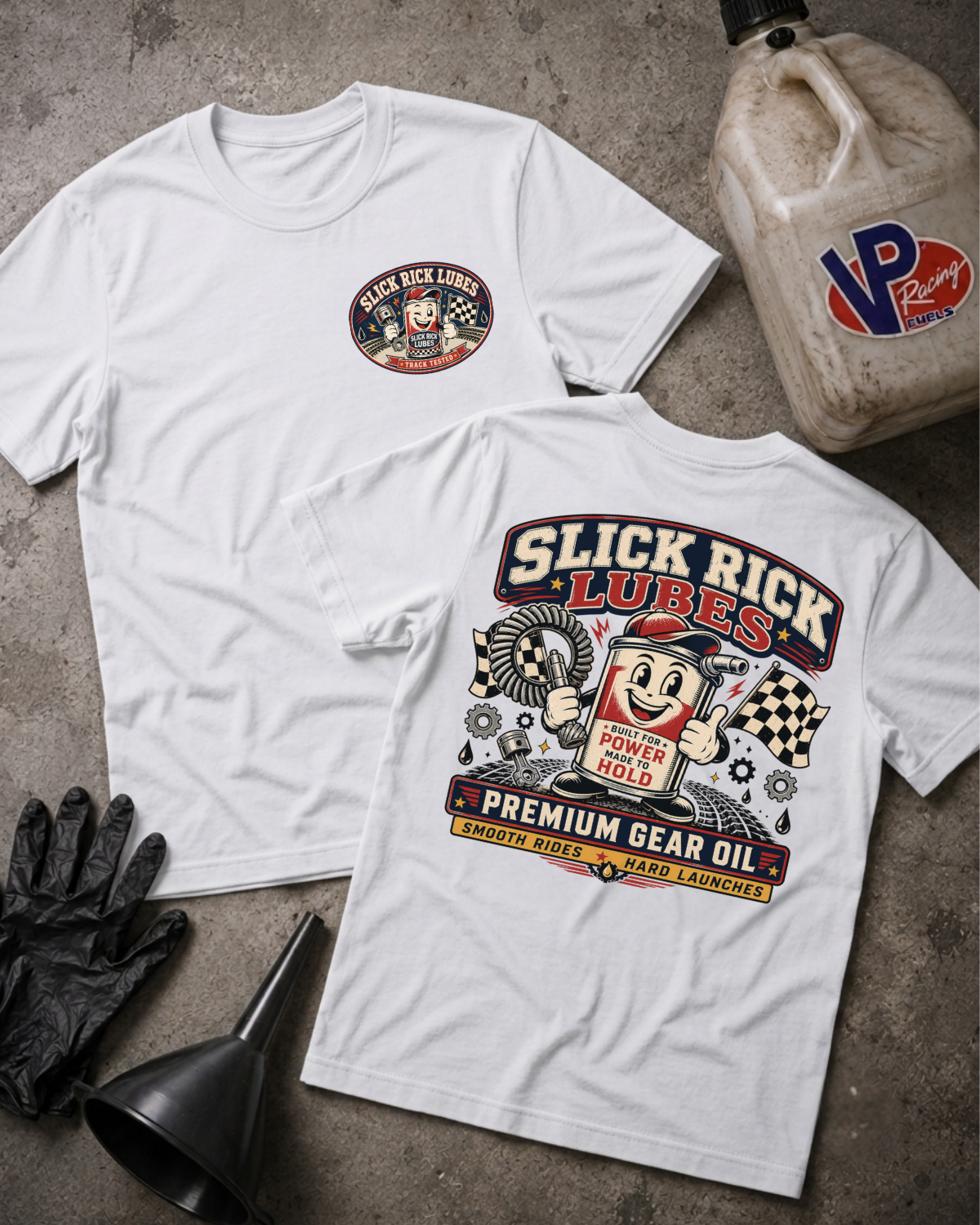 Two white graphic T-shirts laid flat on a gray concrete surface, with a black funnel, black gloves, and a VP Racing jug as styled props. The front shirt shows a small circular chest graphic reading 'Black Rick Lubes,' and the back shirt shows a large colorful 'Slick Rick Lubes' graphic with a cartoon character and text including 'Premium Gear Oil Smooth Rides Hard Launches.'