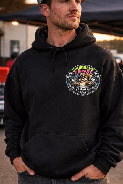 Man wearing a black hoodie with a 'Squirrel's Lug Nuts' logo standing in the pit crew area at a drag race