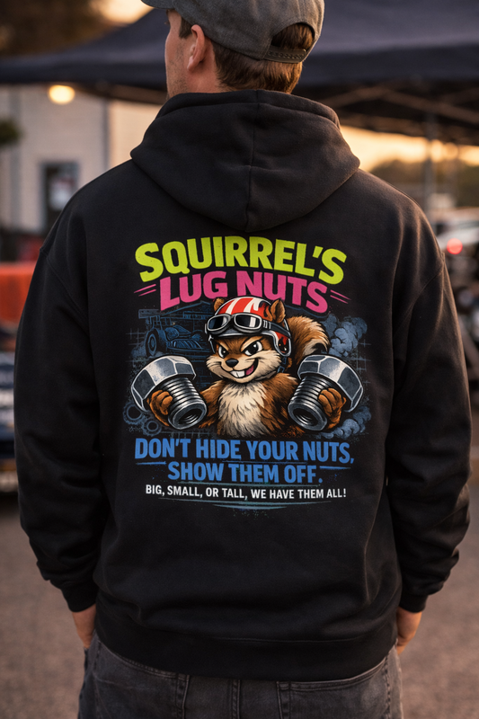 Man wearing a black hoodie with a graphic of a squirrel holding lug nuts and 'Squirrel's Lug Nuts Don't Hide Your Nuts, Show Them Off Big, Small, or Tall, We Have Them All' text, standing in the pit crew area at a drag race