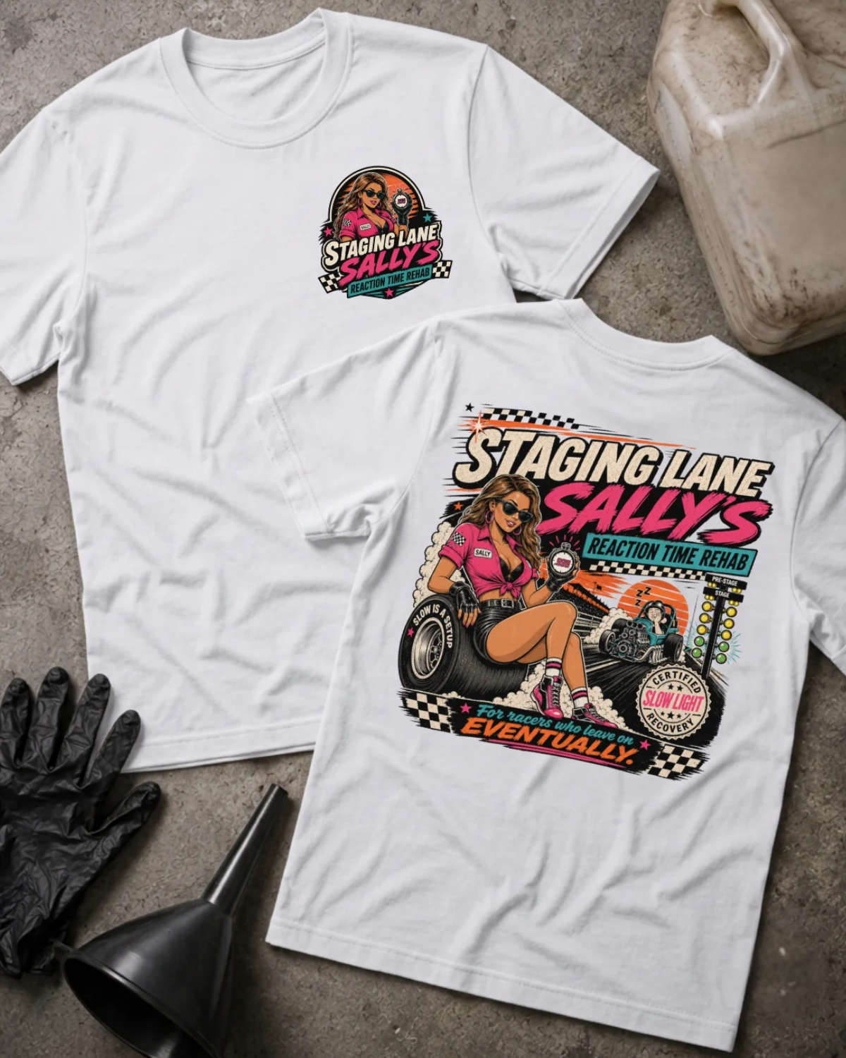 Front and back of Staging Lane Sally’s white T-shirt with chest logo, woman holding a stopwatch seated on a racing tire, and “For racers who leave on eventually” slogan.