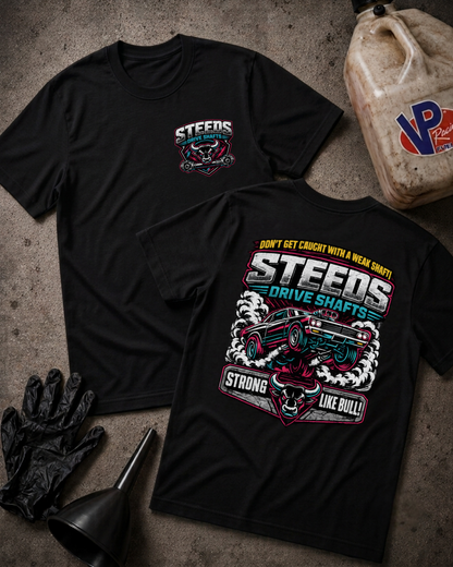 Two black graphic T-shirts laid flat on a textured gray surface, with a large front chest logo on one shirt and a large back graphic on the other. The graphics feature the word STEEDS and a cartoon race car with text including 'STRONG LIKE BULL!'.