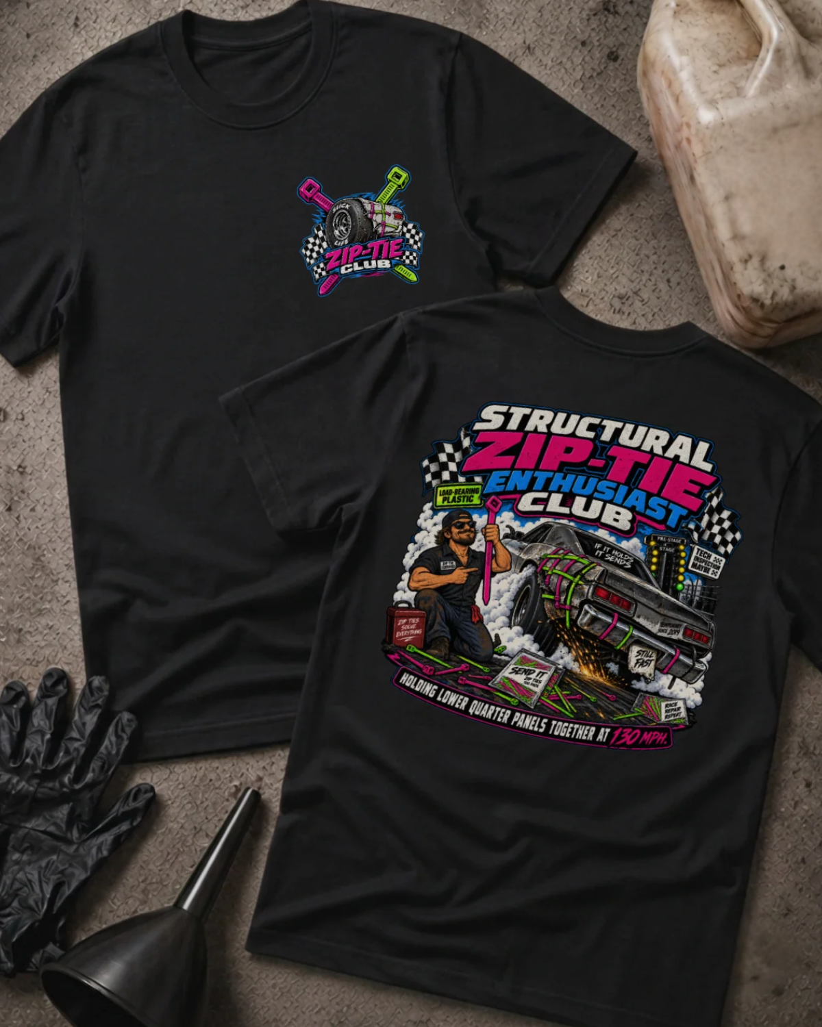 Front and back of Structural Zip-Tie Enthusiast Club black T-shirt with chest logo, mechanic holding a pink zip tie, and drag car secured with colorful zip ties.