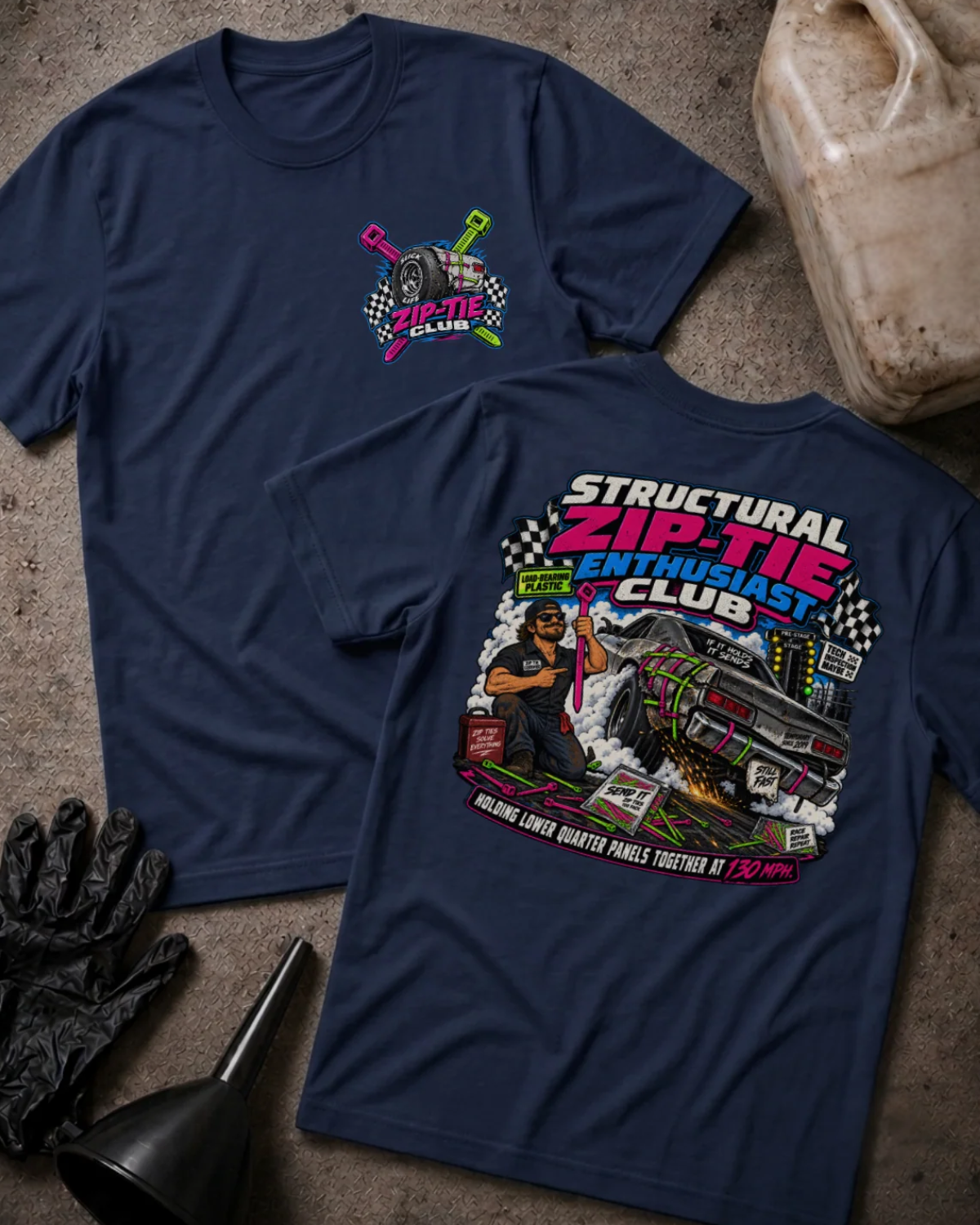 Front and back of Structural Zip-Tie Enthusiast Club navy T-shirt with chest logo, mechanic holding a pink zip tie, and drag car secured with colorful zip ties.