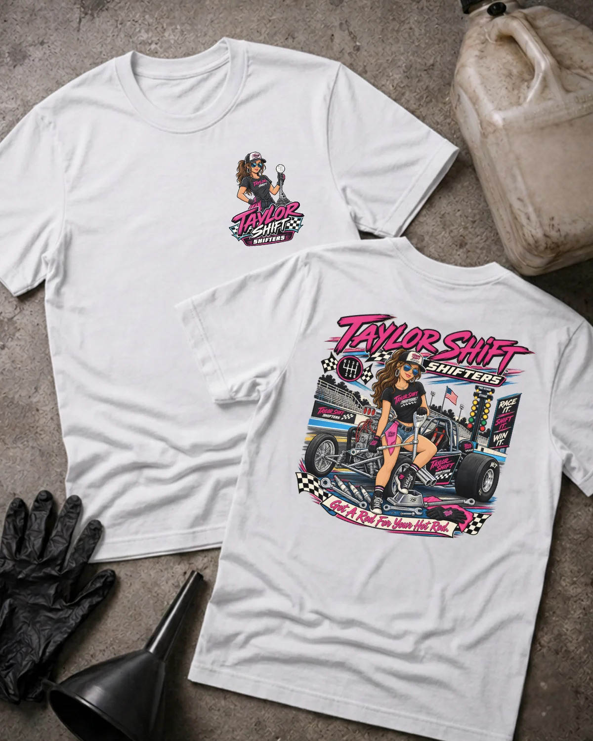 Two white graphic T-shirts laid flat on a concrete surface, showing the front and back designs. The shirts feature a colorful race-themed print with the text 'Taylor Shift Shifters' and an illustrated woman beside a race car.
