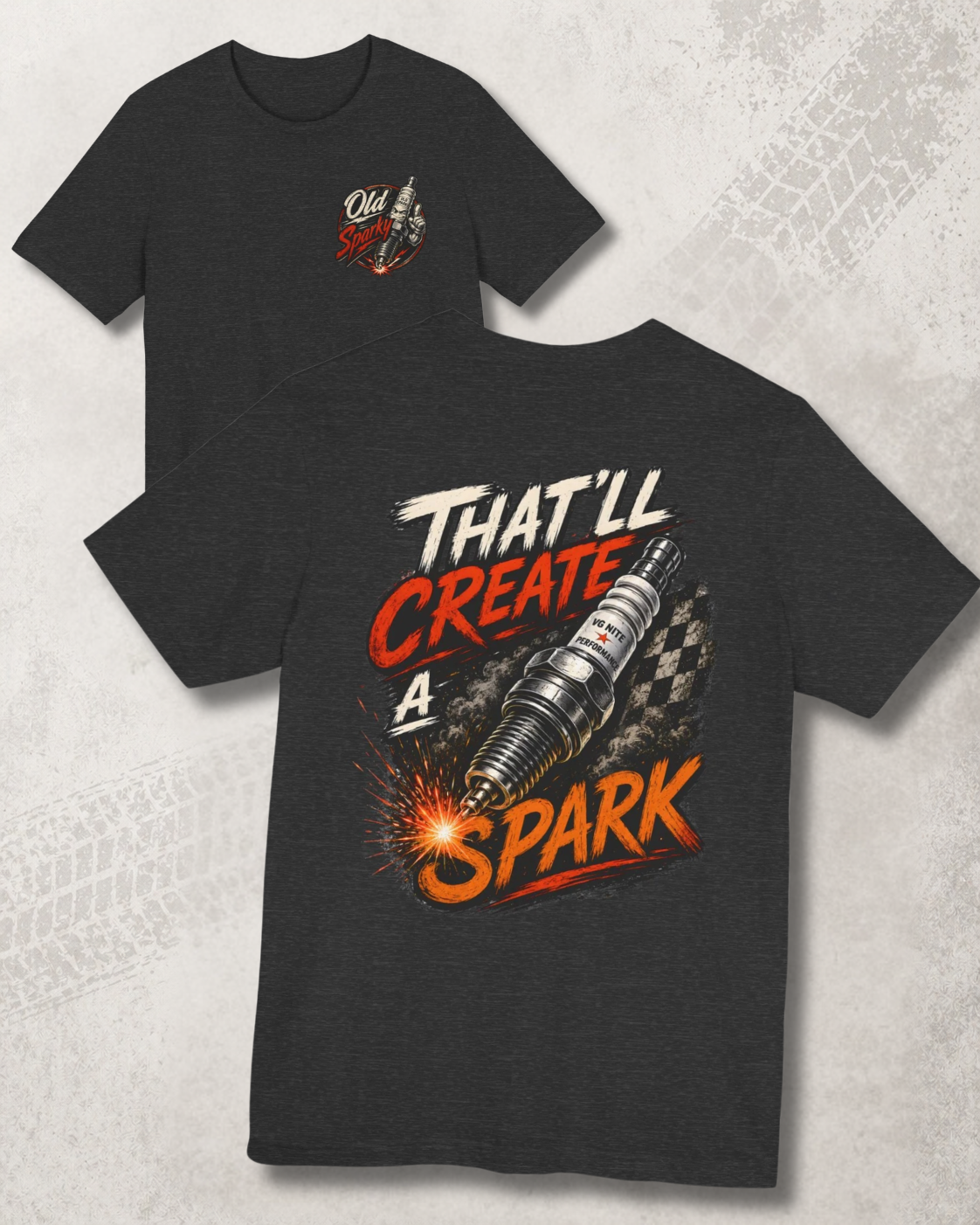 Dark grey heather t-shirt with graphic design and 'That'll create a spark' text on a textured gray background