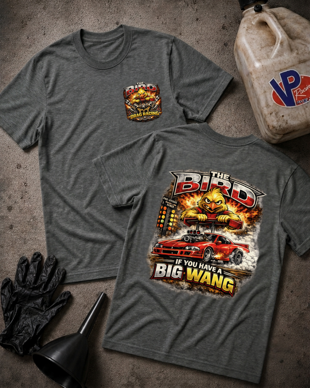 Two heather gray graphic T-shirts laid flat on a textured gray surface, showing the front and back designs. The front has a small chest graphic reading 'The Bird' with a bird illustration and 'If You Have A Big Wang' text.