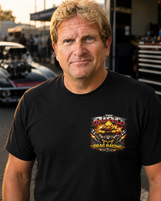 Man wearing a black t-shirt with 'The Bird Drag Racing' logo in an outdoor setting.