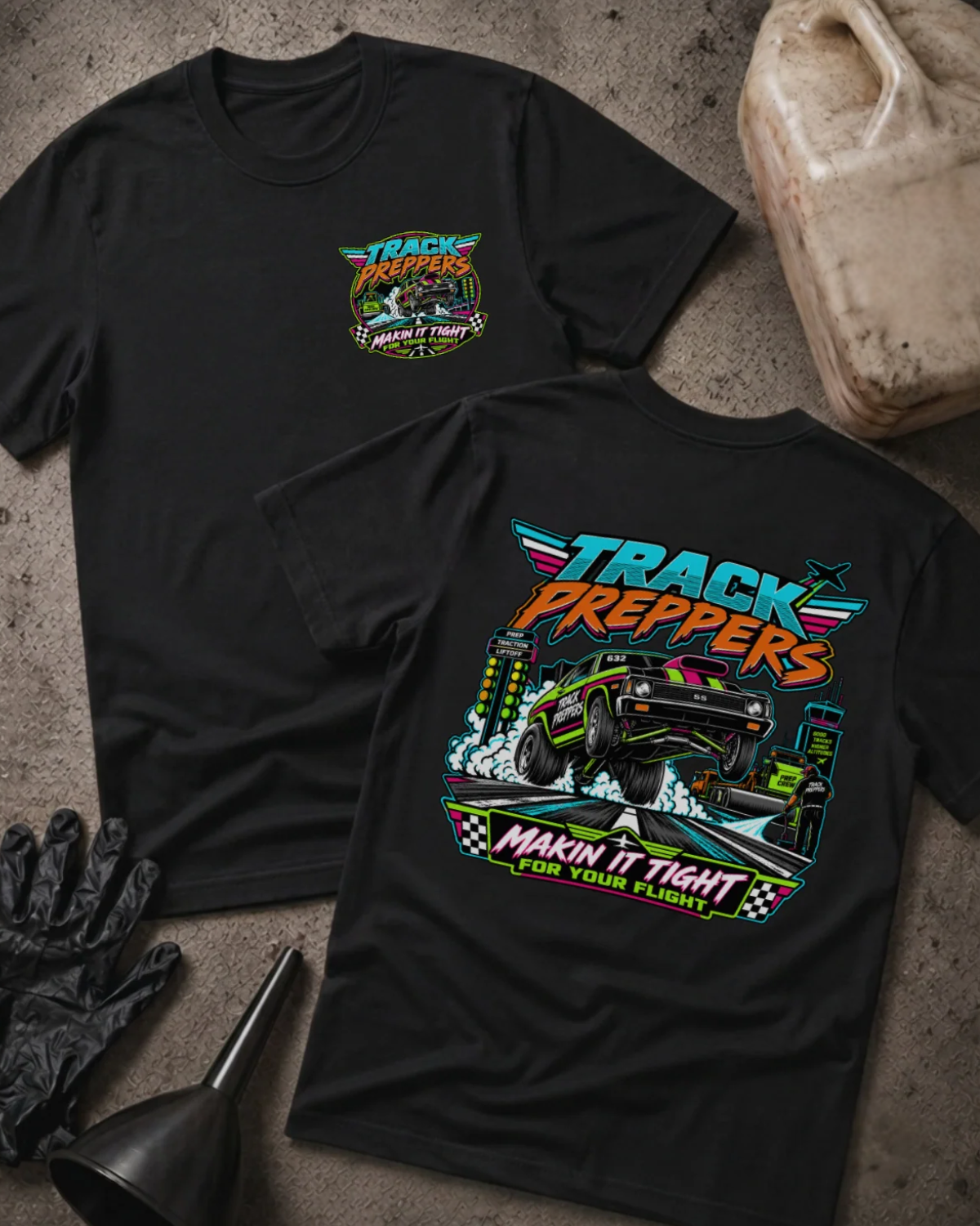 Front and back of Track Preppers black T-shirt with chest logo, drag car lifting its front wheels beside staging lights, and “Makin’ it tight for your flight” slogan.
