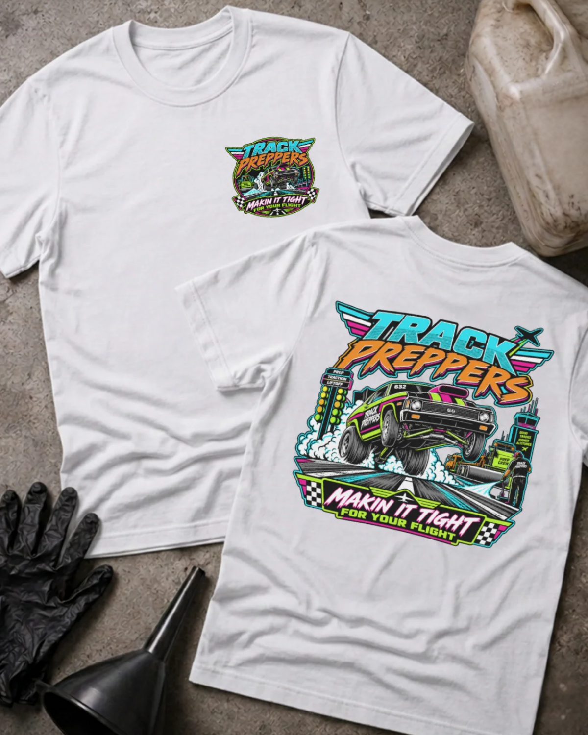 Front and back of Track Preppers white T-shirt with chest logo, drag car lifting its front wheels beside staging lights, and “Makin’ it tight for your flight” slogan.