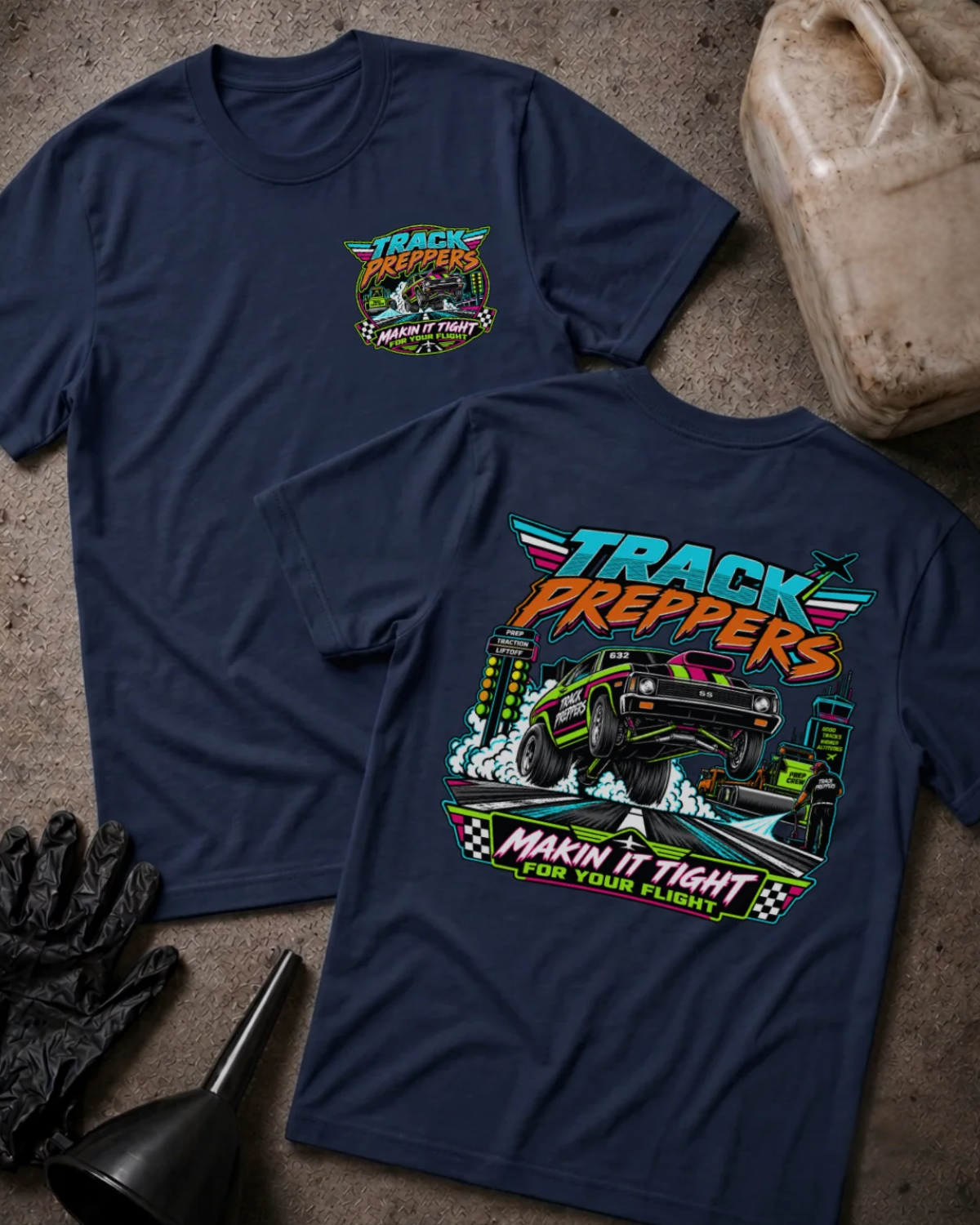 Front and back of Track Preppers navy T-shirt with chest logo, drag car lifting its front wheels beside staging lights, and “Makin’ it tight for your flight” slogan.